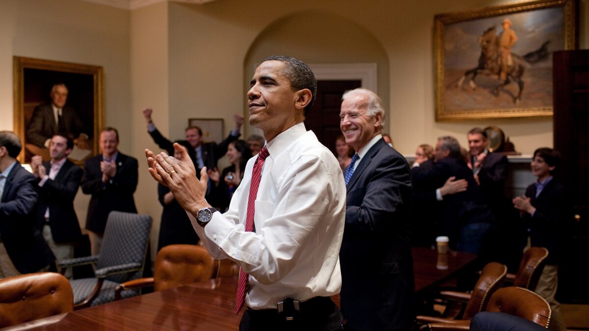 President Barack Obama, Vice President Joe Biden, and senior staff applaud for healthcare bill