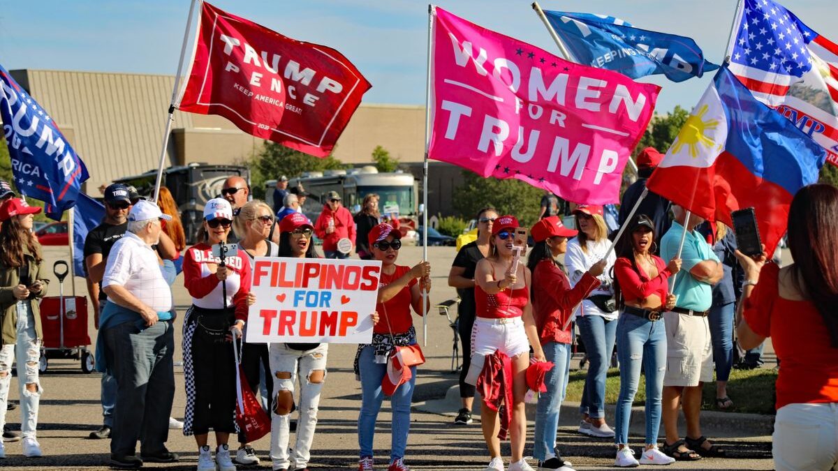 Trump supporters holding flags.