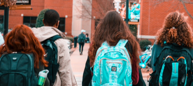 college students with backpacks, discrimination and adversity score