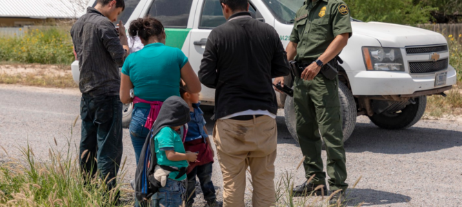 Border Patrol officer with migrants