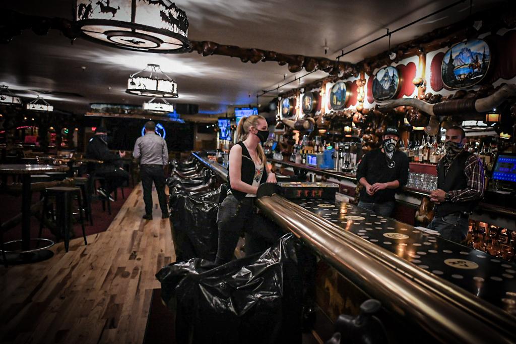 A waitress catches up with the bartenders at Jackson's Million Dollar Cowboy Bar. Martin Avila.