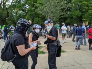 Radicals distribute masks for pepper spray. Photo by Christopher Bedford/The Federalist.