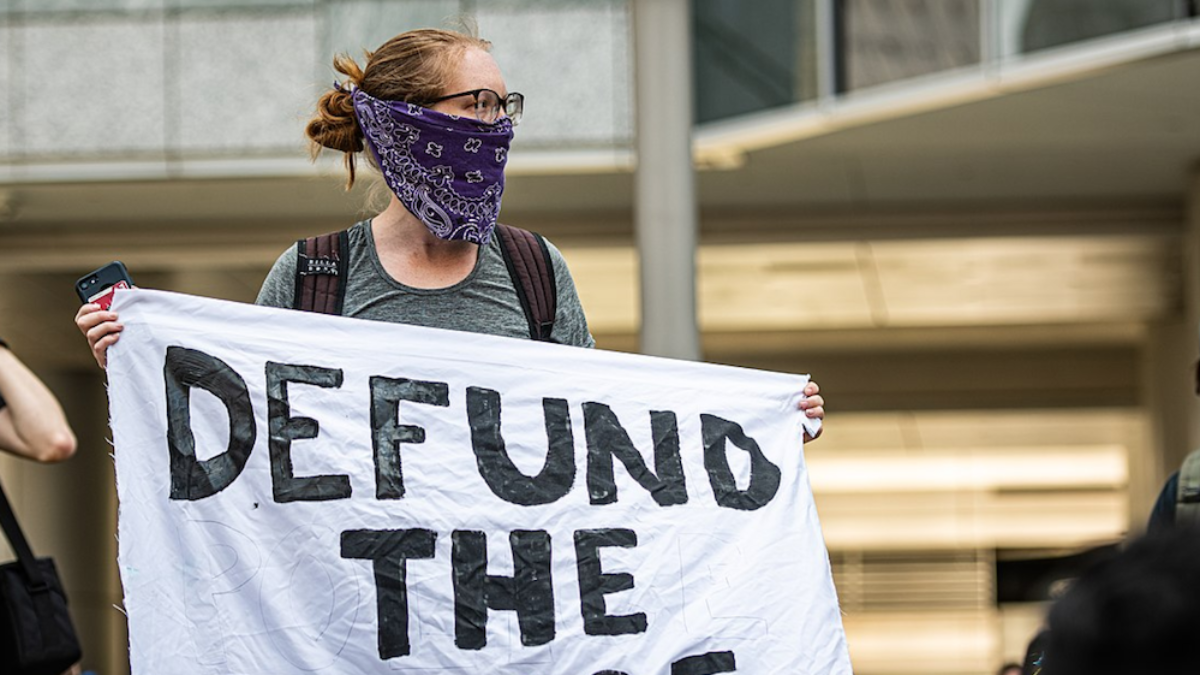 defund the police banner protest