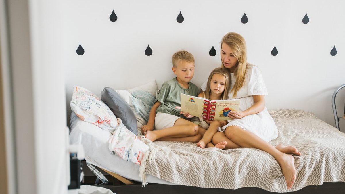 Woman reading book to kids