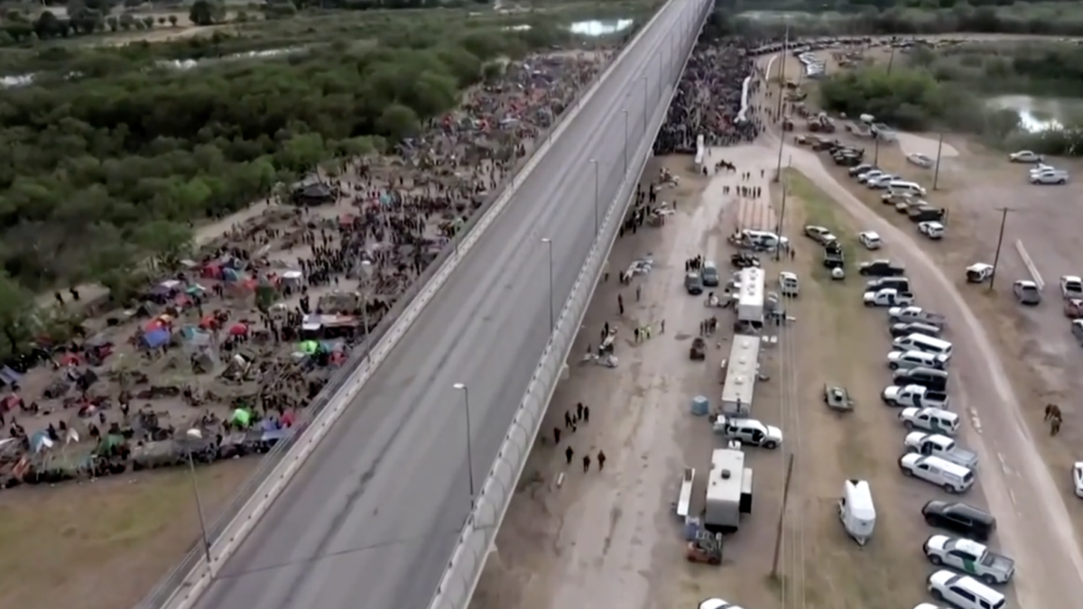 Migrants under a bridge