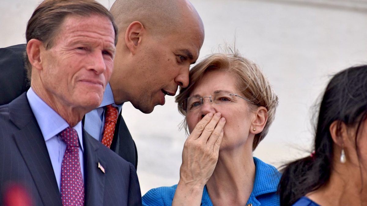 Cory Booker whispers to Elizabeth Warren