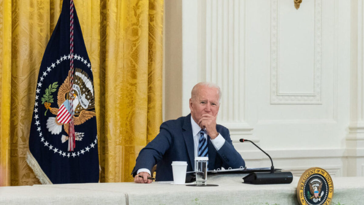 Biden sitting at a table