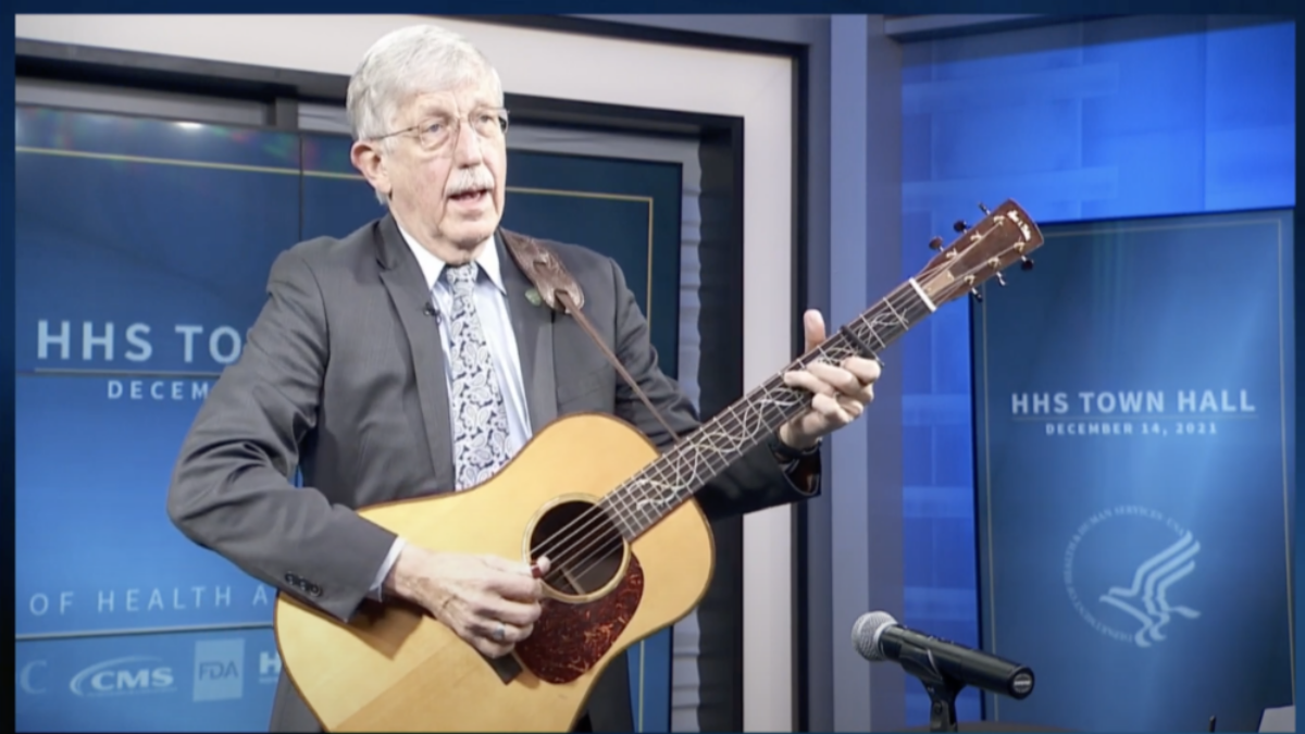 Francis Collins playing guitar and singing