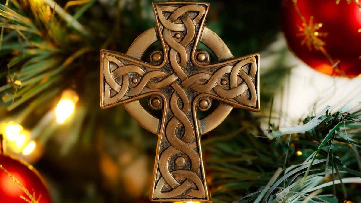 Cross ornament on Christmas tree.