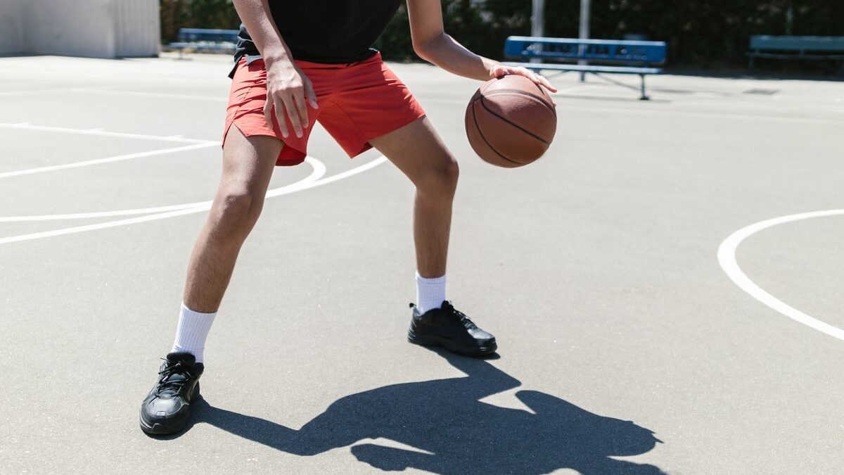 Person dribbling basketball.