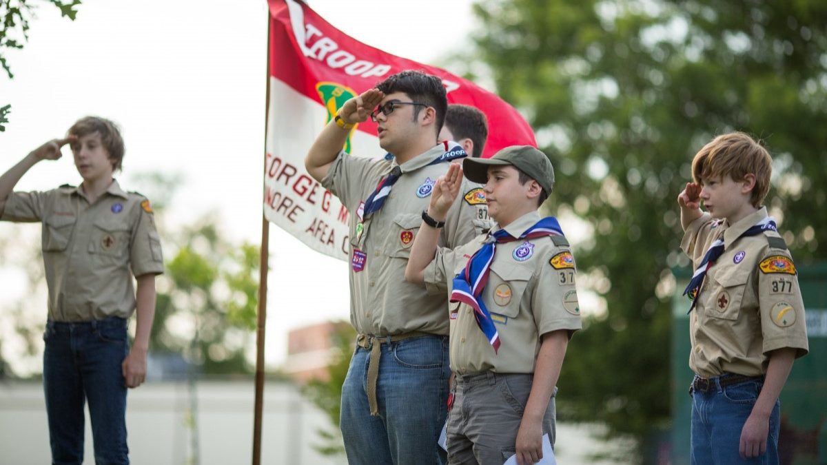Boy Scouts retire a flag