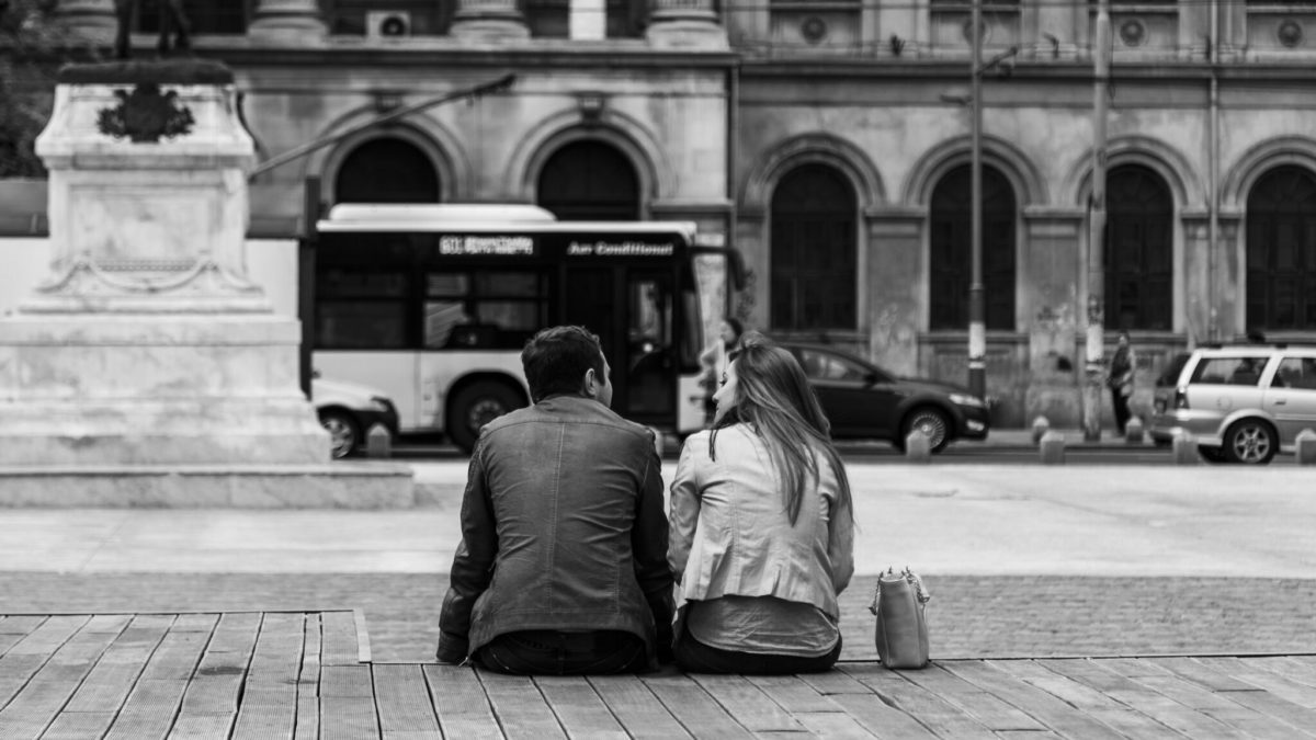 man and woman sitting on steps together