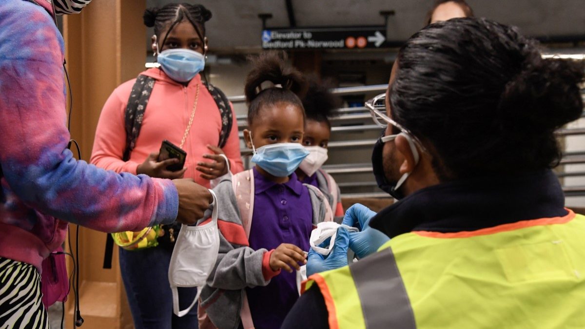 volunteers handing out masks for adults and children