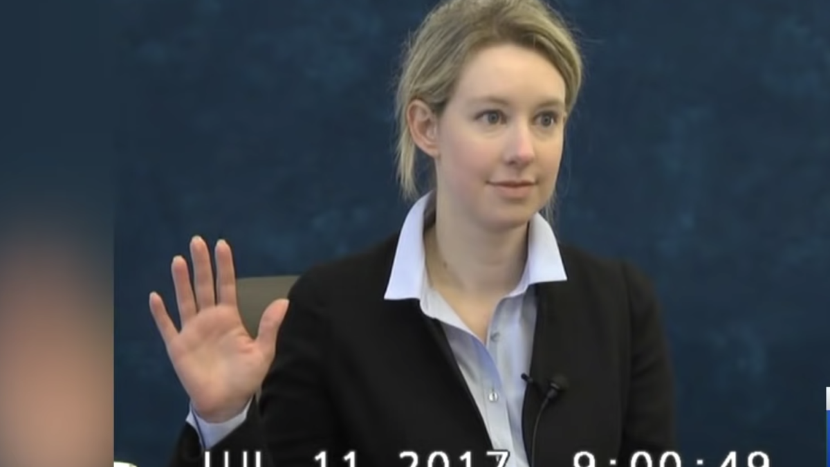 woman raising hand in deposition video