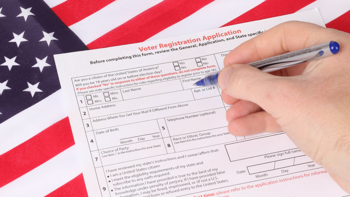 person filling out voter registration form
