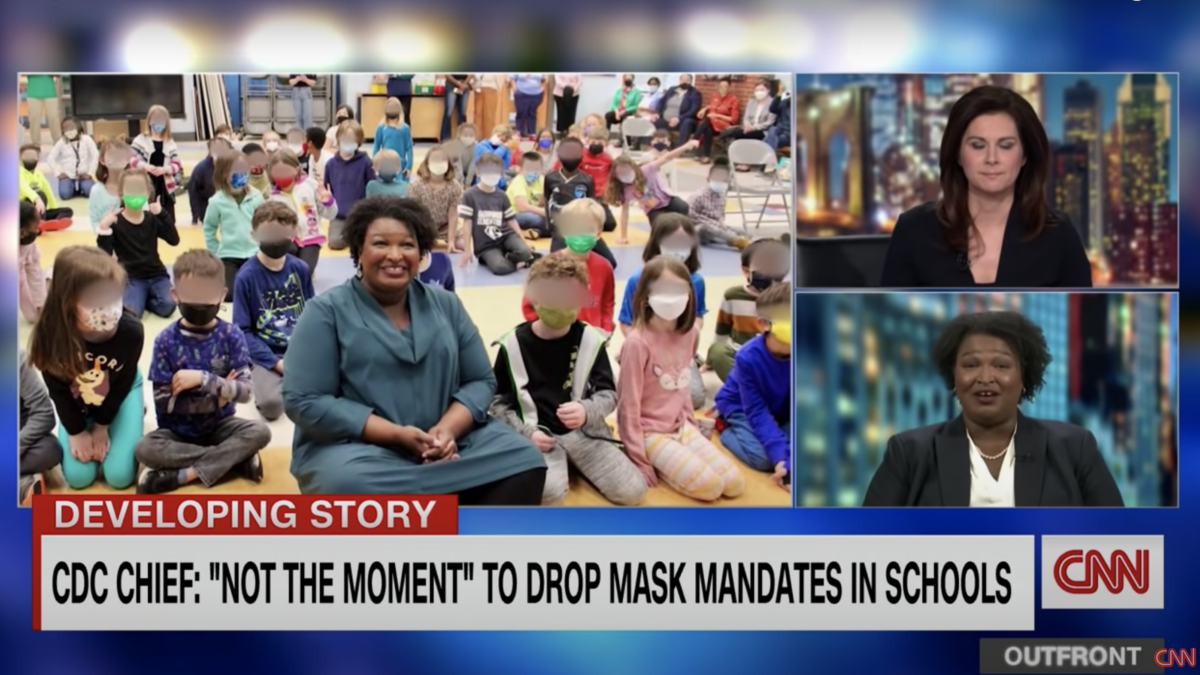 Stacey Abrams poses maskless with masked kids