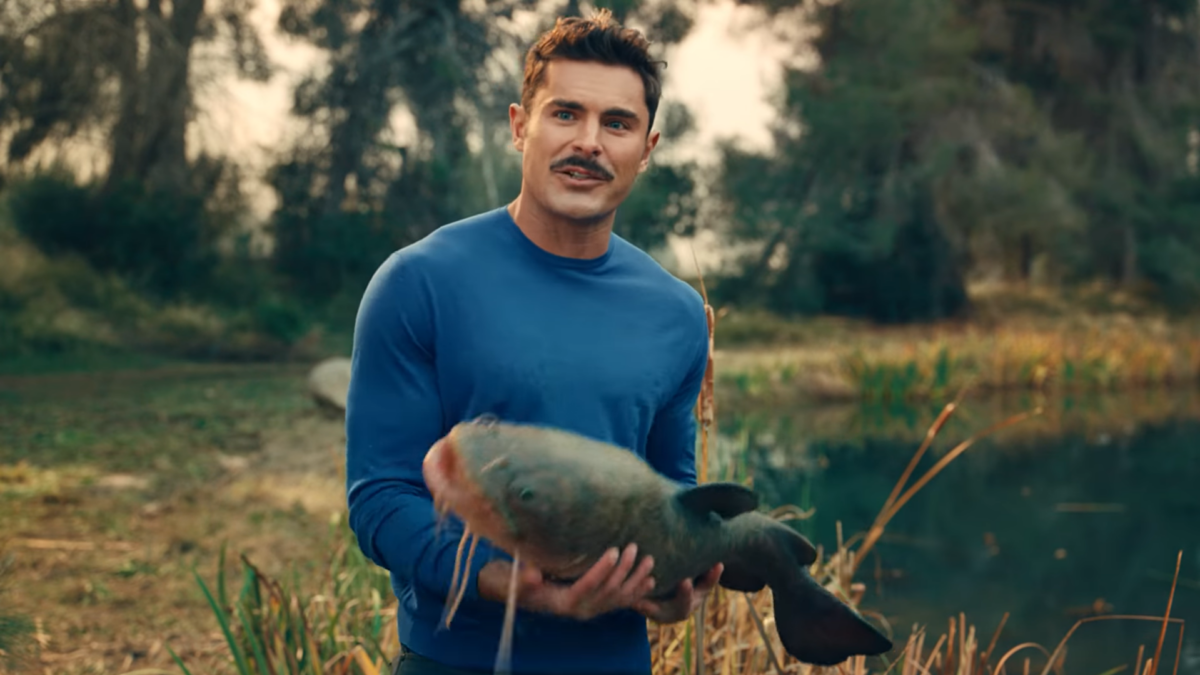Zac Efron holding a fish in AT&T ad