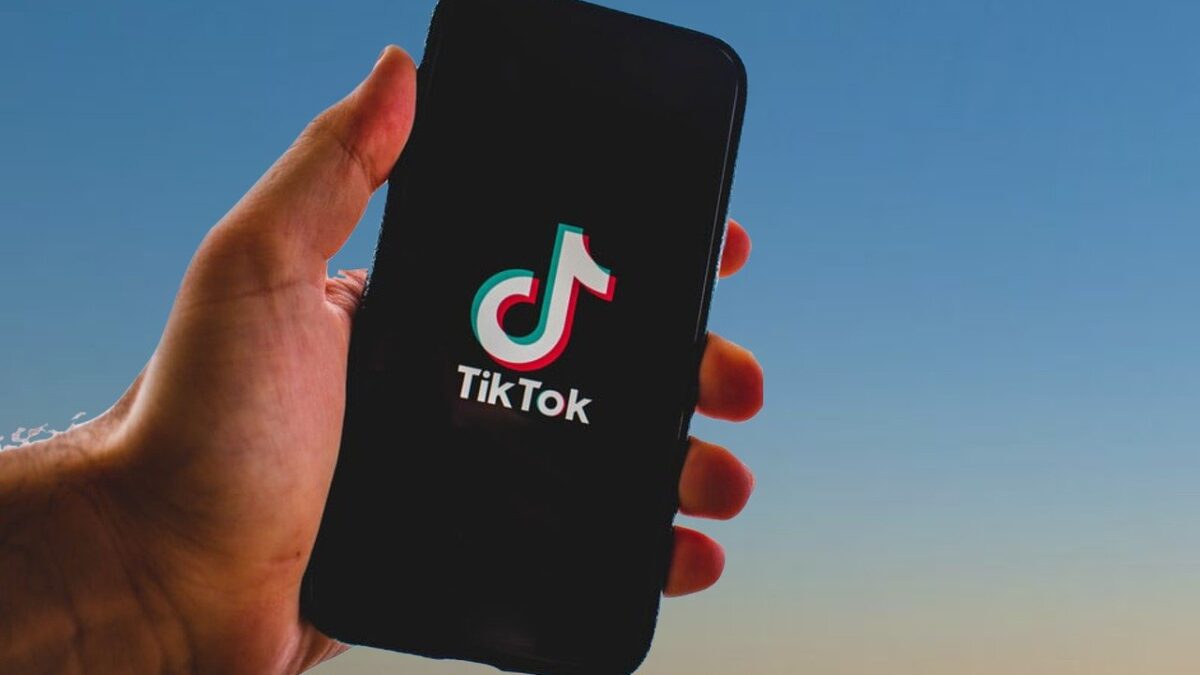 hand holding phone with Tiktok