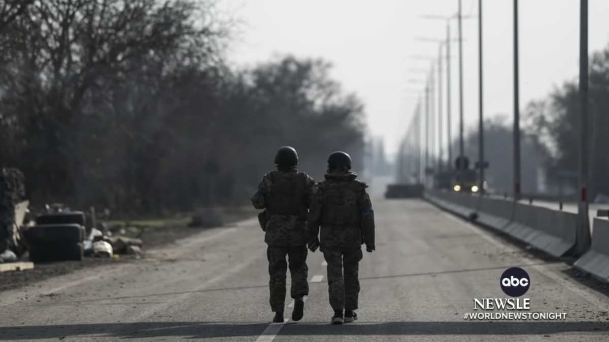 two soldiers walking down road