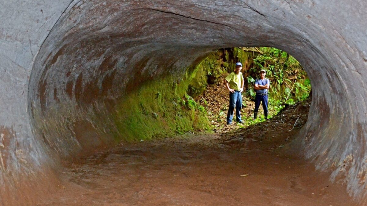 two men standing in giant tunnel