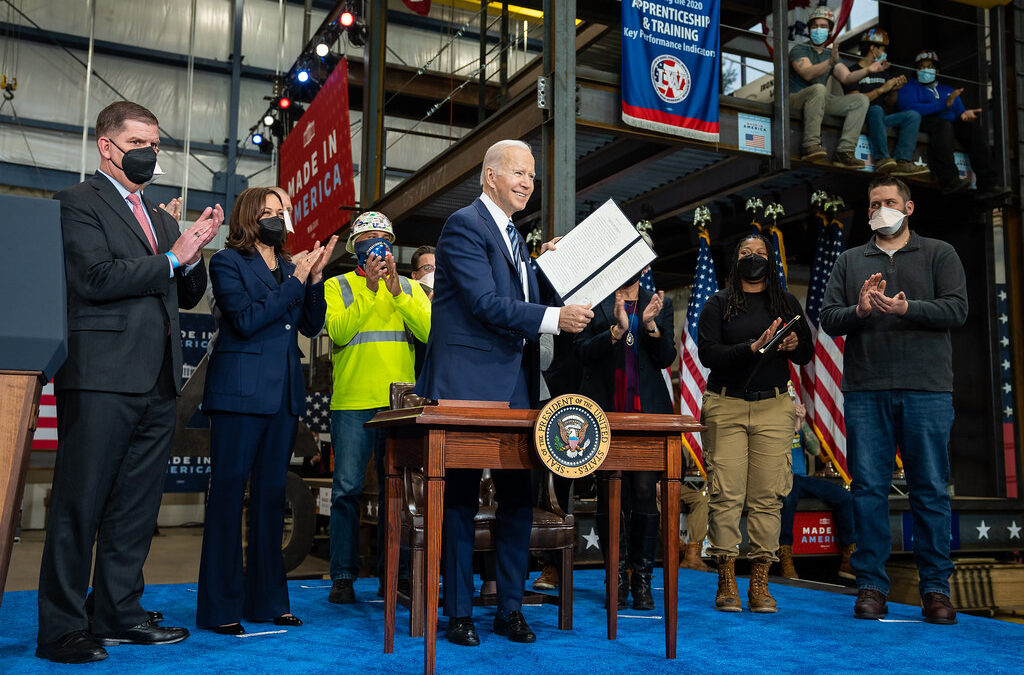 biden holding up executive order in front of union workers