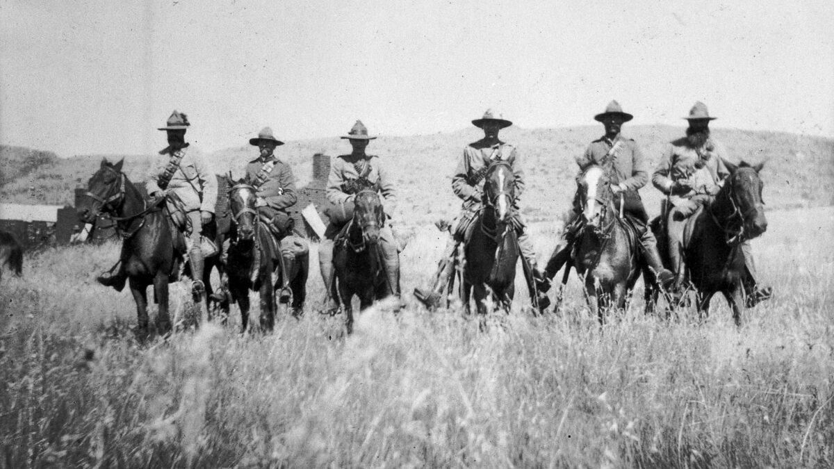 men on horseback in open field