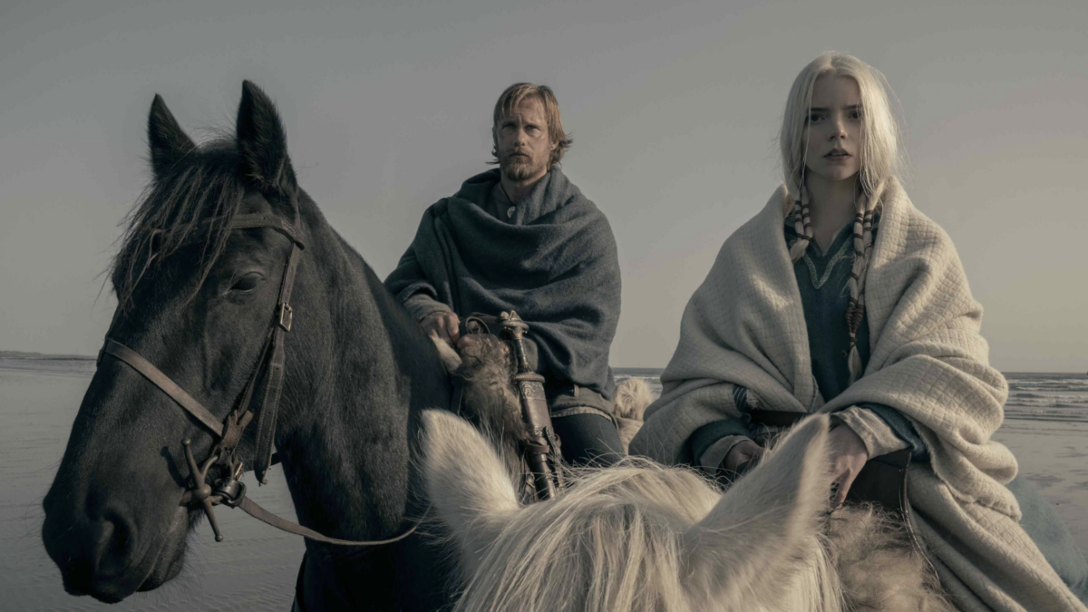 Two vikings riding on horseback