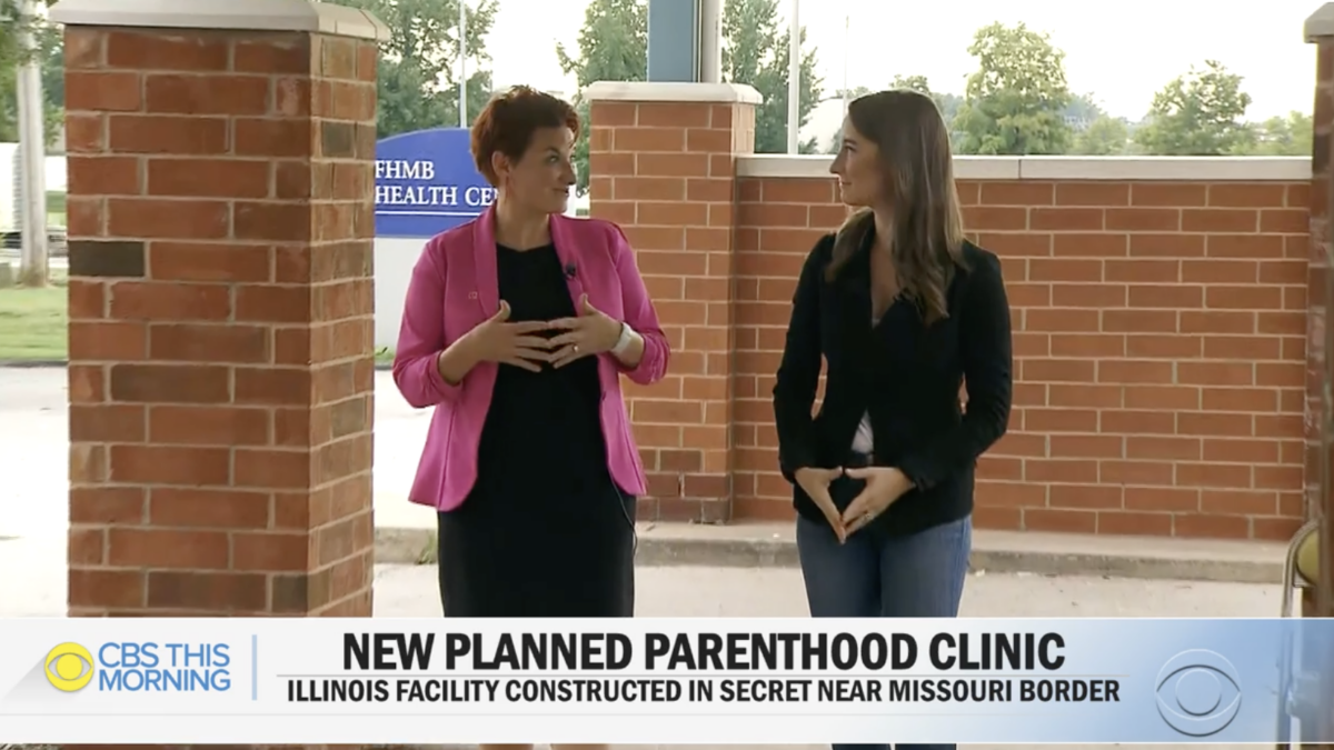 two women walking and talking at abortion facility