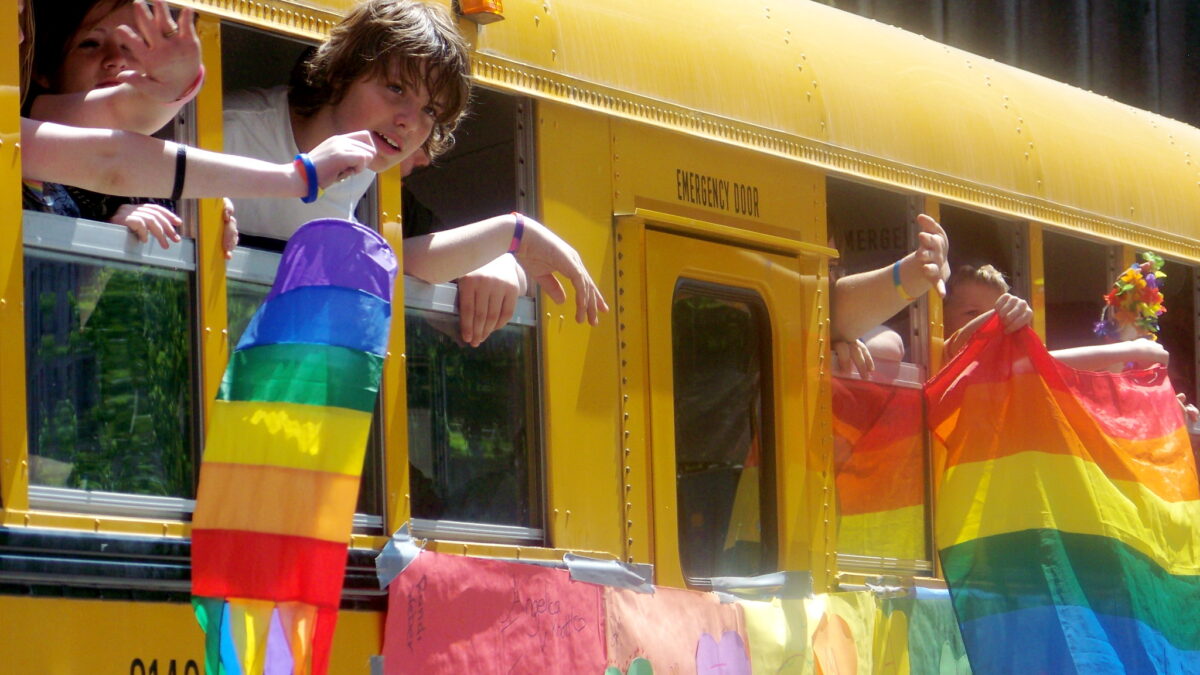 pride flags on a school bus