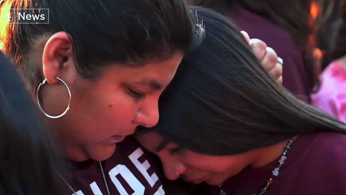 mass shootings grieving, mother holds crying daughter