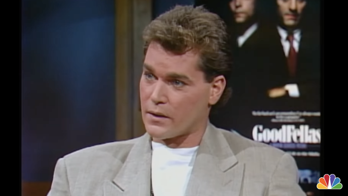Ray Liotta wearing a blazer sitting for an interview in 1990