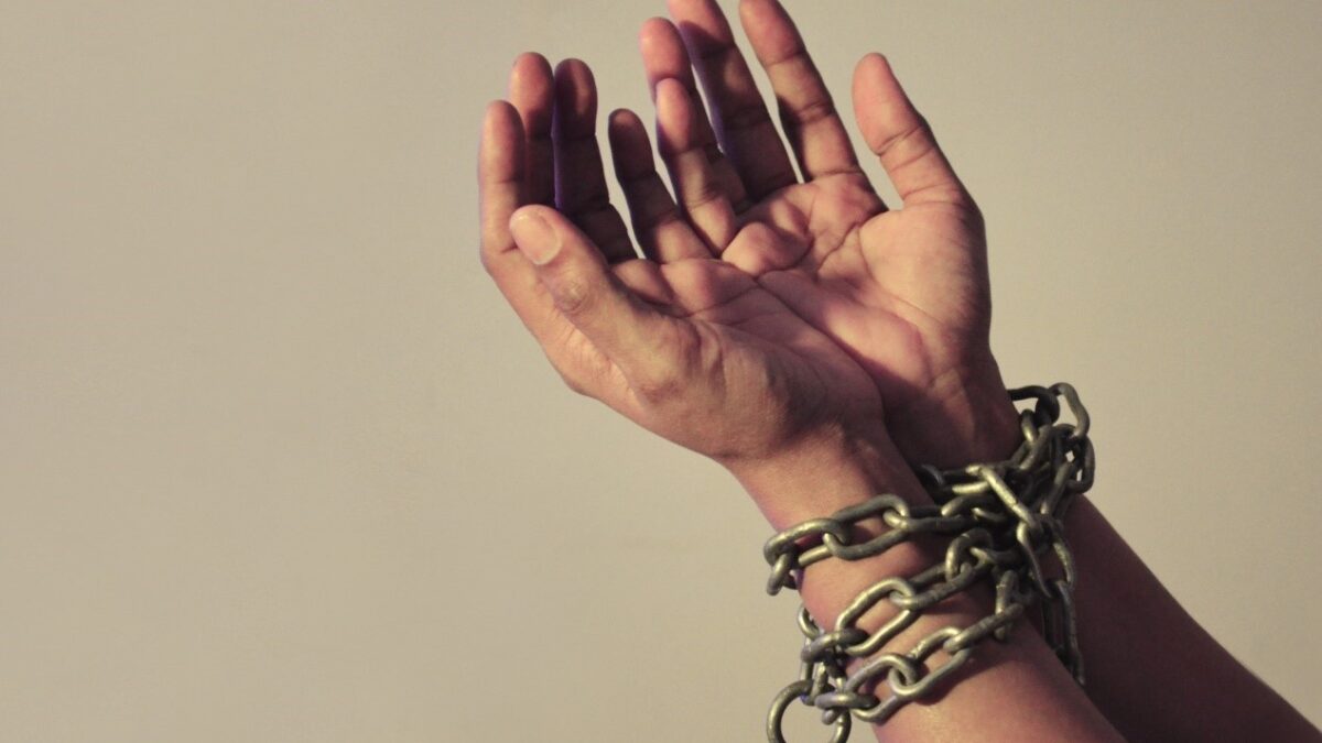 hands with chains around wrists
