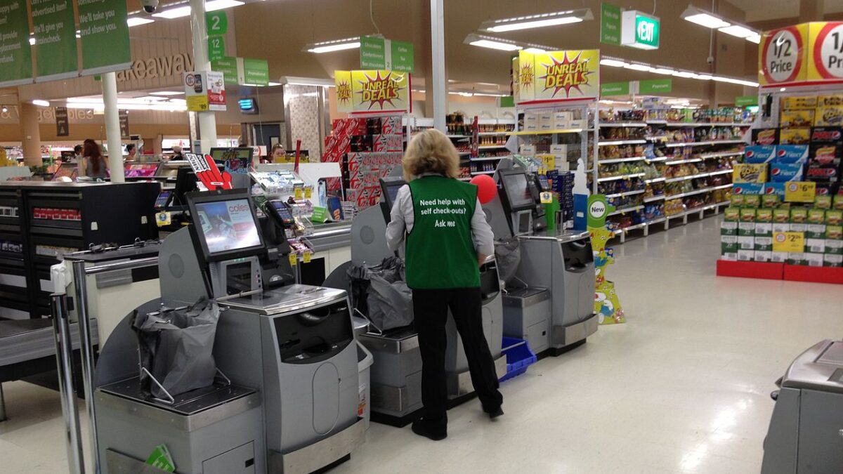 grocery worker at self-check out station