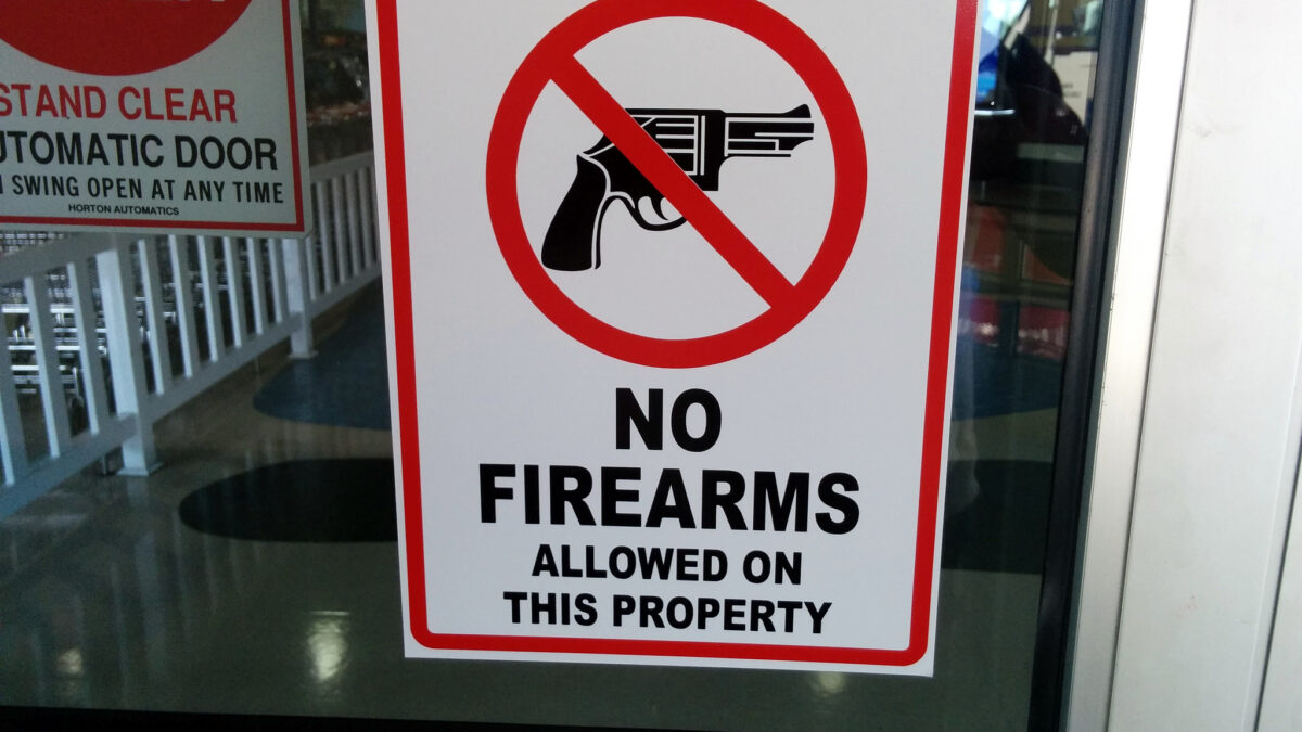 gun free zone sign hanging on door
