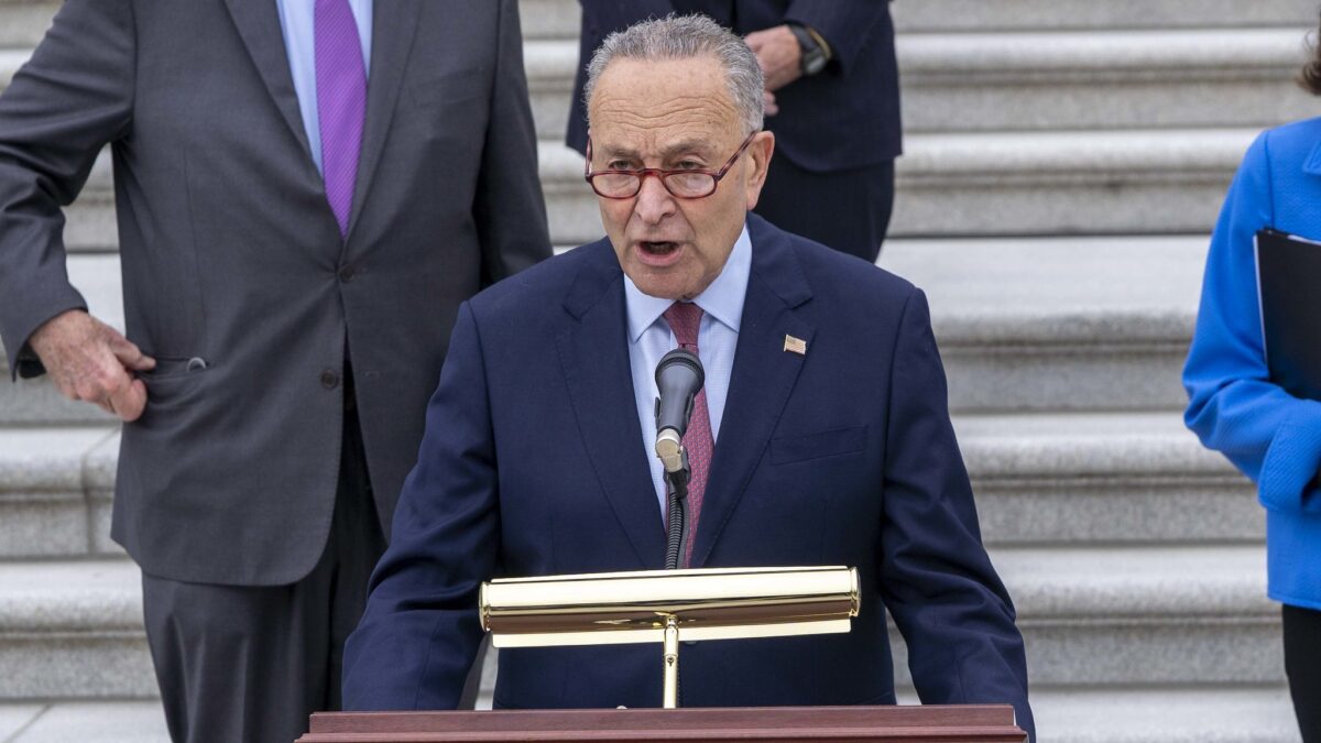 chuck schumer speaking from podium on capitol steps