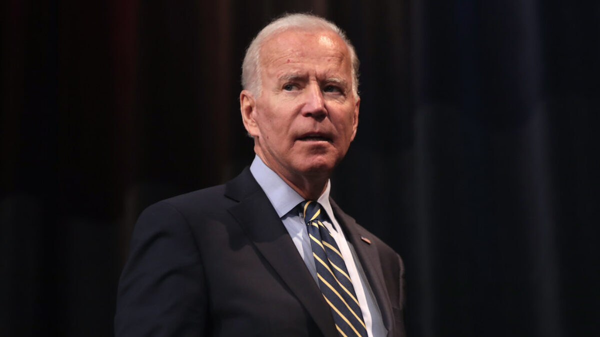 Joe Biden looking concerned in front of a black backdrop.