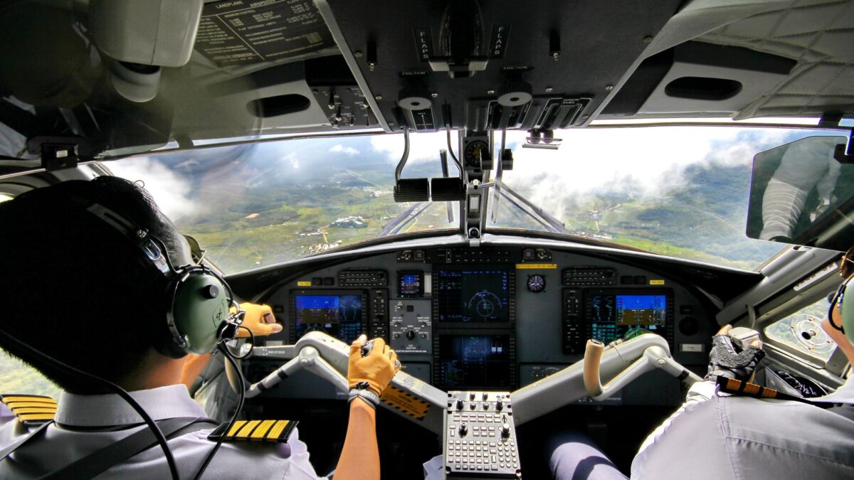 pilots in cockpit of plane landing