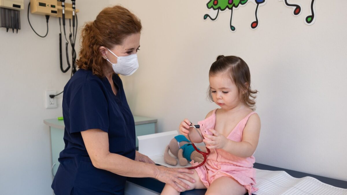 A nurse with a little girl.