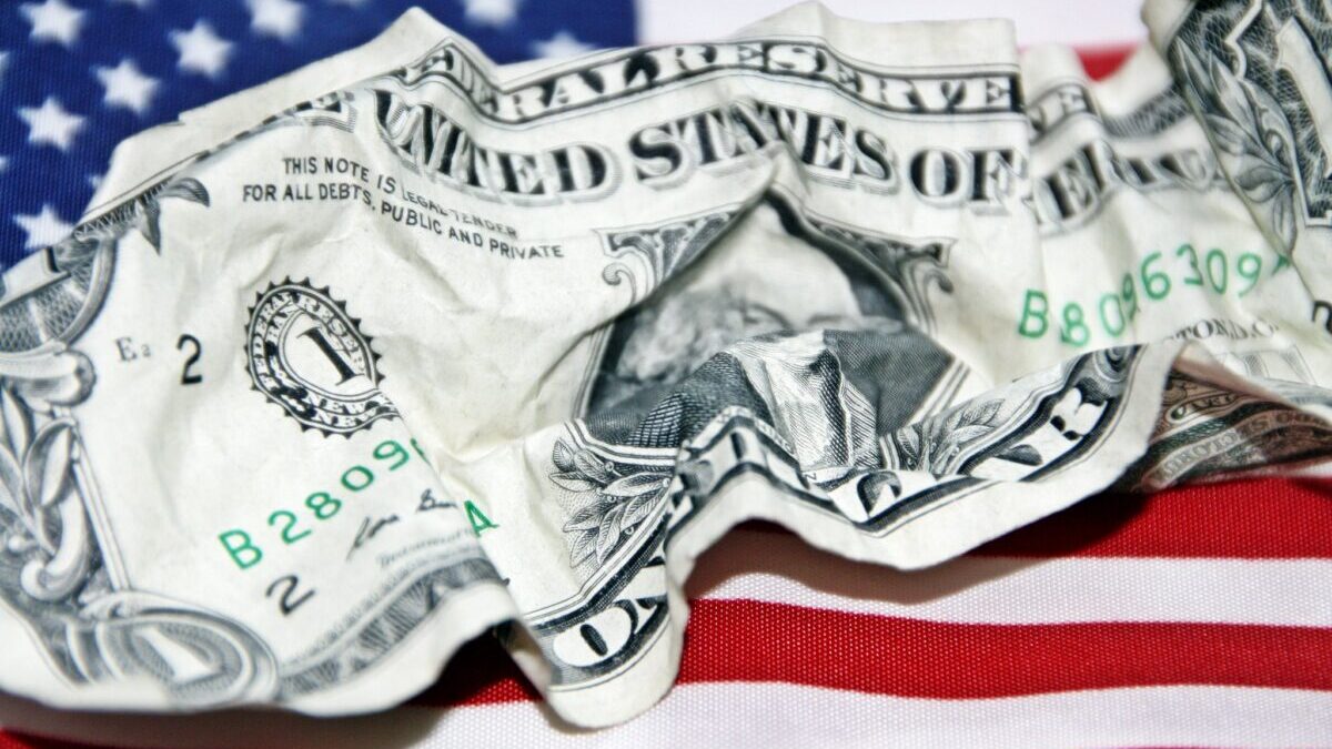 Cash crumpled on an American flag