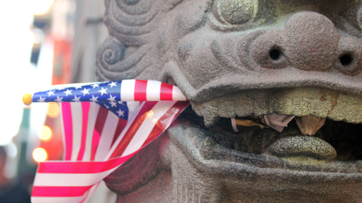 dragon statue eating american flag