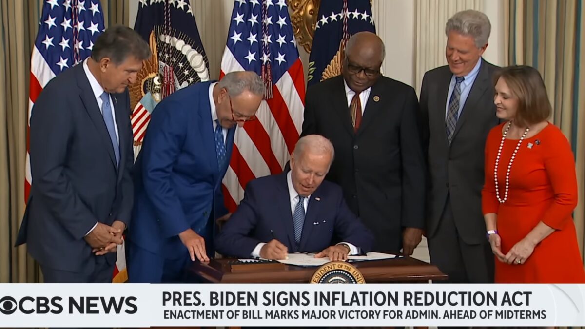 Joe Biden signing the Inflation Reduction Act into law