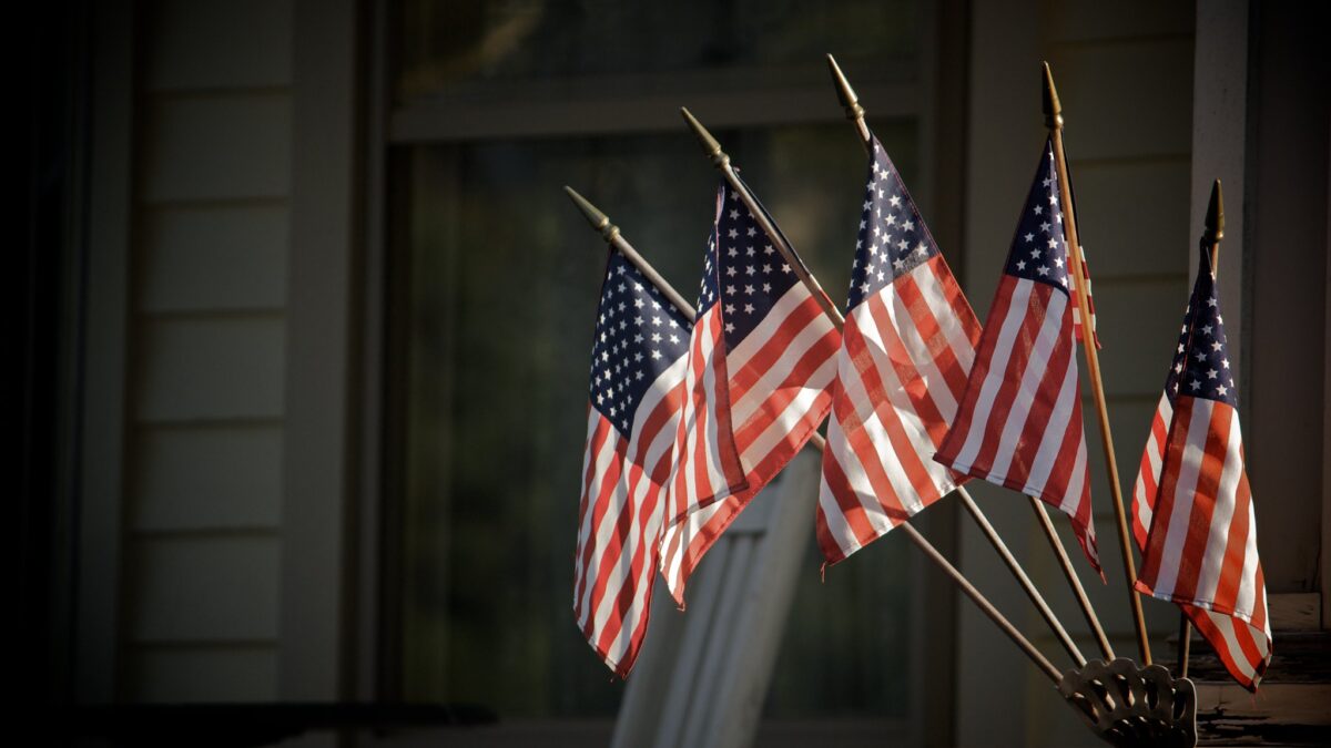 five american flags outside building
