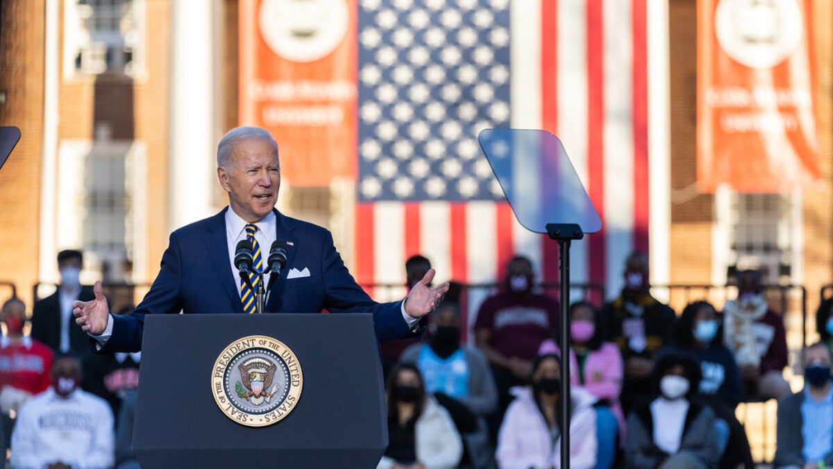Biden speaking outside in front of American flag