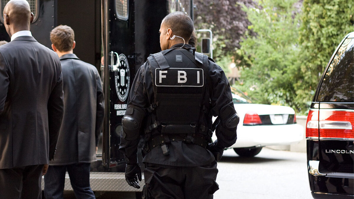 man wearing FBI gear standing outside swat truck