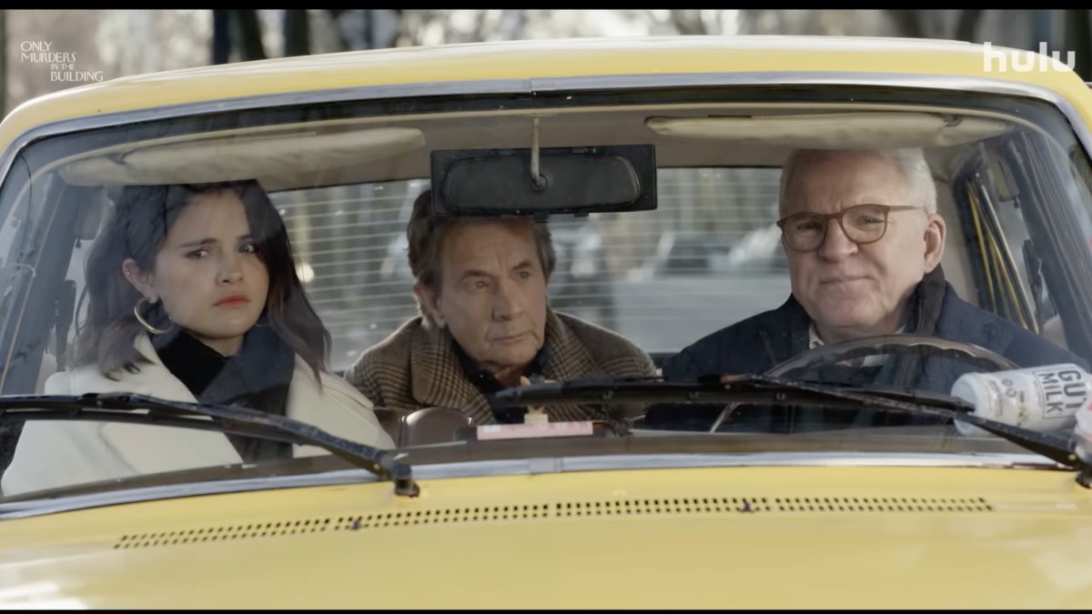 three characters sitting in yellow car