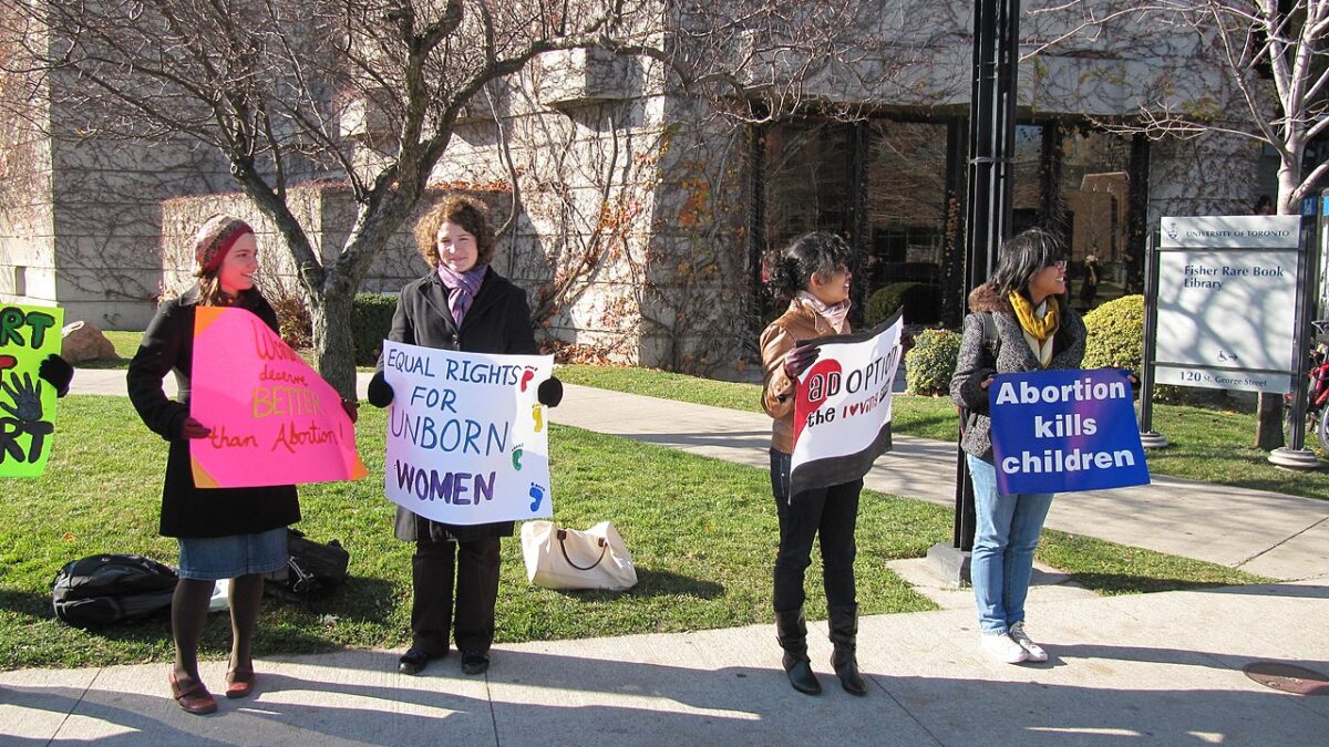 pro-life protesters holding signs