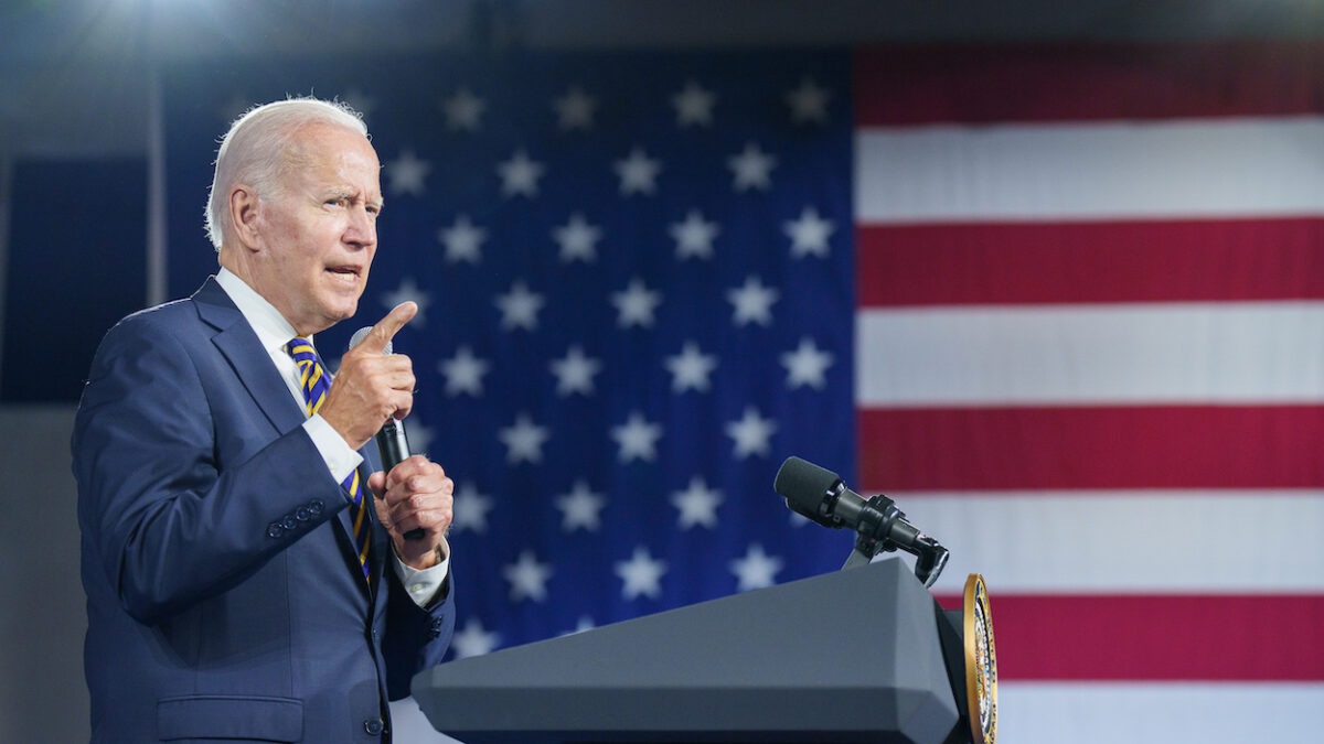 Joe Biden speaking in front of American flag