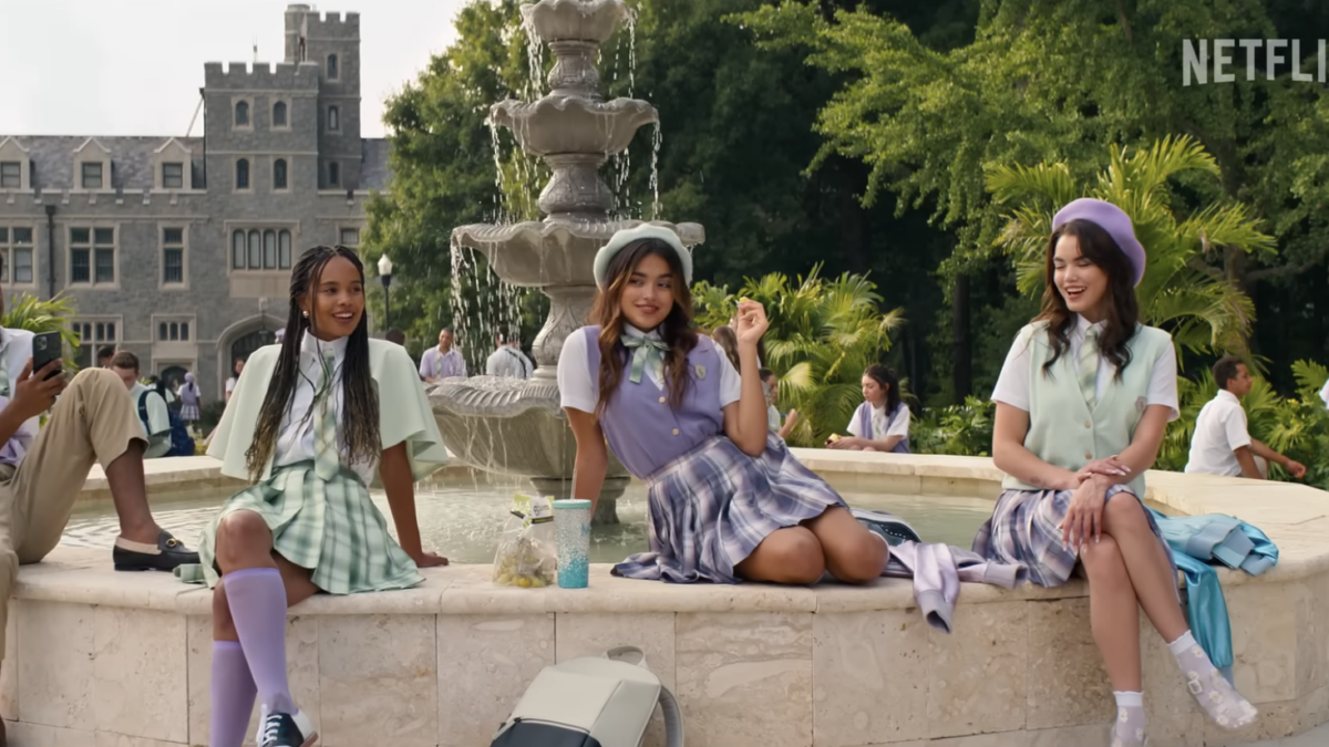 teens in school uniforms sit around fountain