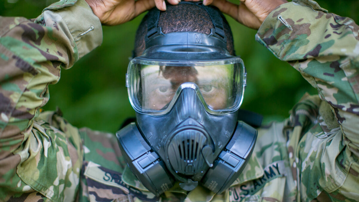 military man in a gas mask