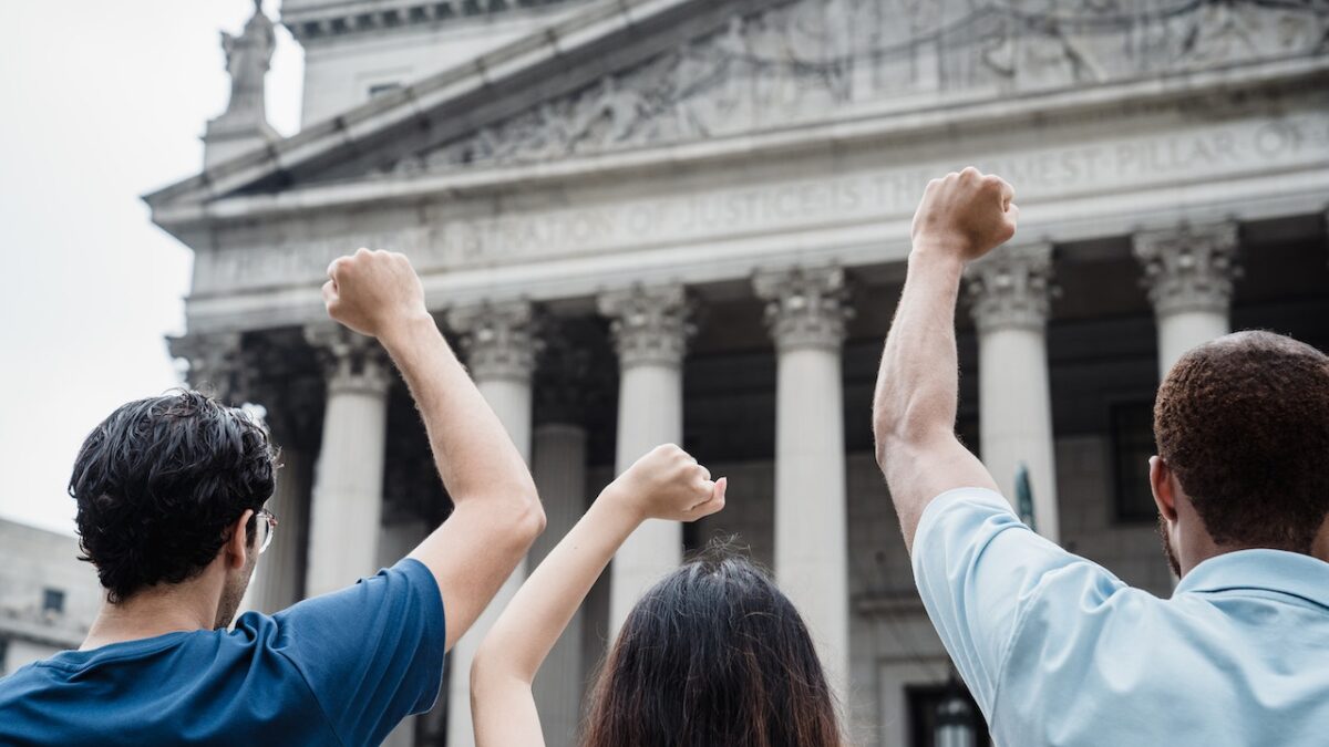 protestors raise fist in front of Supreme Court